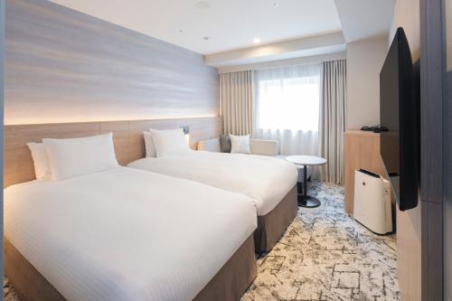 Una cama o camas en una habitación de La'gent Stay Sapporo Odori Hokkaido
