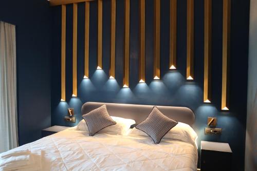 a bedroom with a bed with two pillows on it at La Giulia Suites like Home in Bonassola