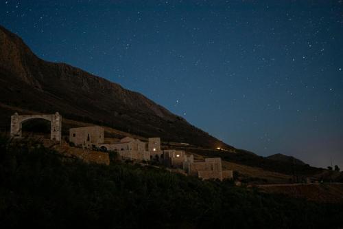 a group of buildings on a hill at night at Anemos Suites Mani 