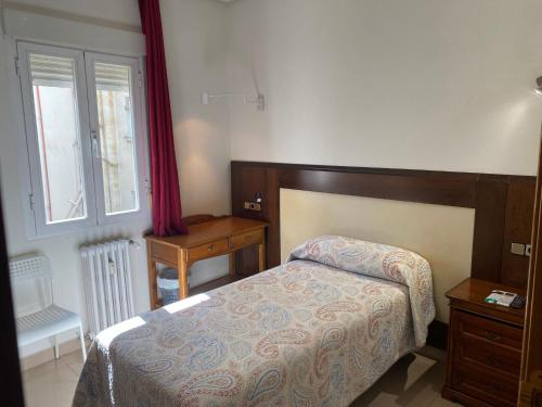 Postel nebo postele na pokoji v ubytování Hostal Retiro