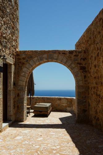 an archway in a building with a view of the ocean at Anemos Suites Mani 