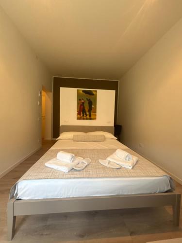 a bedroom with a bed with two towels on it at Studio Venice Mestre Centrale in Venice