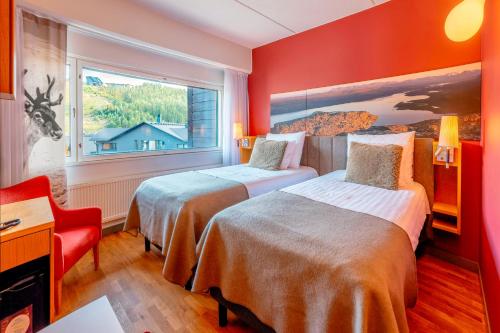 a hotel room with two beds and a window at Break Sokos Hotel Levi in Levi