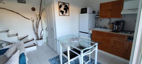 a small kitchen with a glass table in it at Casa Di l'alba in Borgo