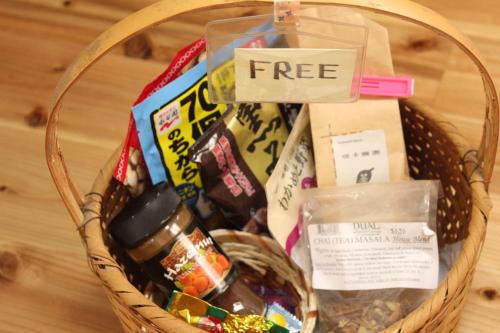 a basket filled with snacks and a sign that reads free at Katsuo Guest House in Kochi