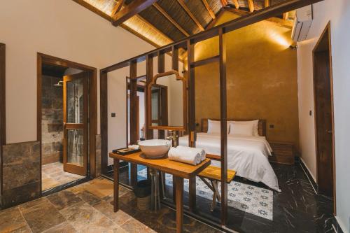 a bedroom with a bed and a table with a bowl on it at Tam Coc Golden Fields Retreat in Vũ Lâm