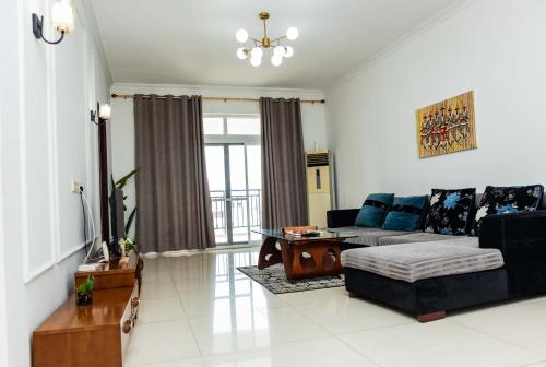 a living room with a couch and a table at Eastern Hills Apartments in Accra