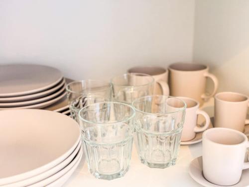 a group of glasses and plates and cups on a table at BIA D'Olaf Apartments in Santa Maria