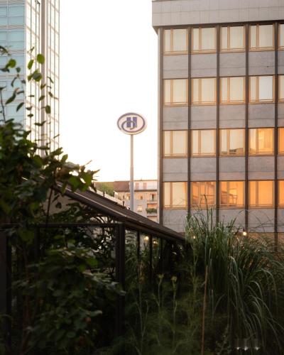 a view of a building with a kia sign in the background at Hilton Milan in Milan