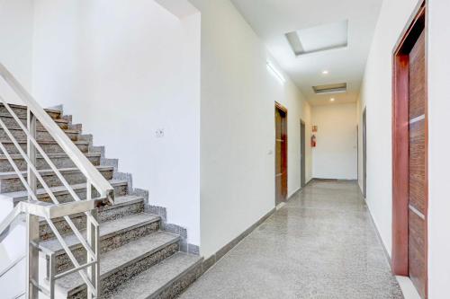 a hallway with stairs and a red door at Collection O Chandigarh Highway Near Prabhat Road in Chandīgarh