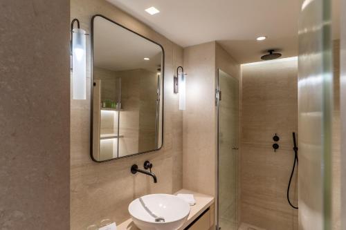a bathroom with a sink and a mirror at Rodos Park in Rhodes Town