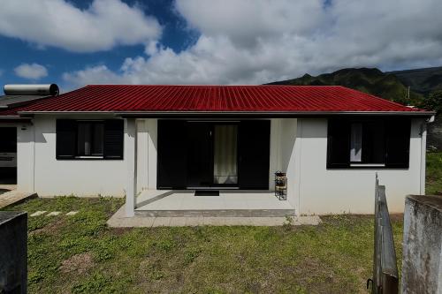 a small white house with a red roof at Maison Arum in La Plaine des Palmistes