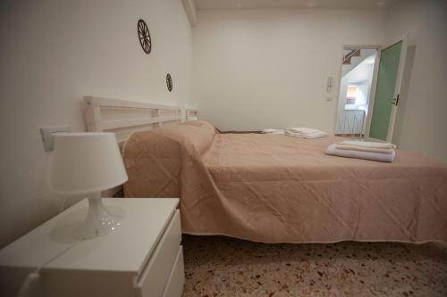 a bedroom with a bed and a mirror and a table at Holiday House Annunziata in Termini Imerese