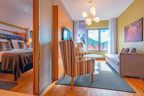 a bedroom with a bed and a living room at Break Sokos Hotel Levi in Levi