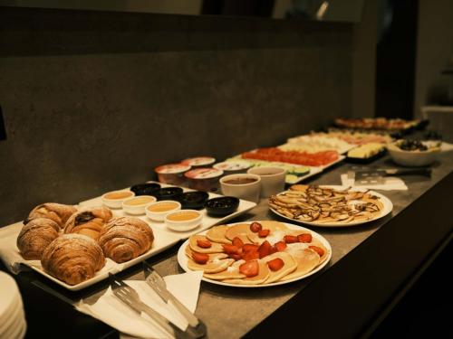 a table with many different types of food on it at The Central View Boutique Hotel in Vlorë
