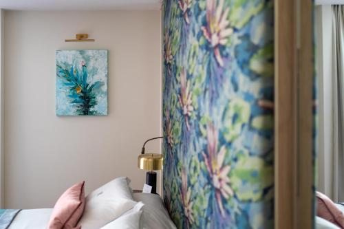 a bedroom with a bed and a colorful wall at Rodos Park in Rhodes Town