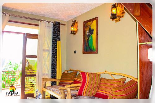 a living room with a couch and a window at Masaka Cultural Resort in Masaka