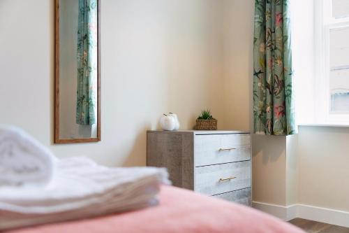 a bedroom with a dresser and a window at Flat1 1BR in Horsemarket in Barnard Castle