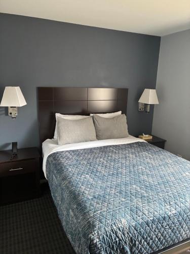 a bedroom with a large bed and two night stands at Mainstay Inn in Phoenixville