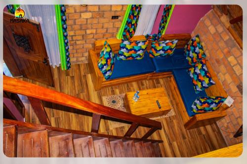 an overhead view of a living room with a blue couch at Masaka Cultural Resort in Masaka