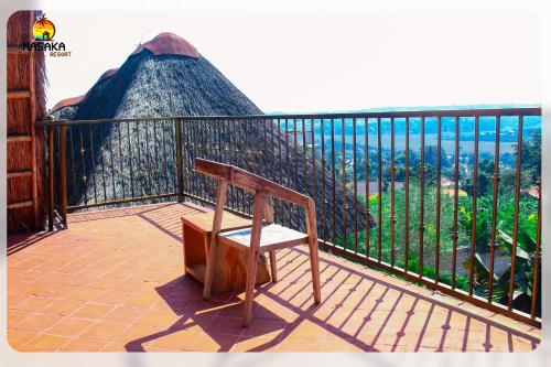 a chair sitting on a balcony with a view at Masaka Cultural Resort in Masaka