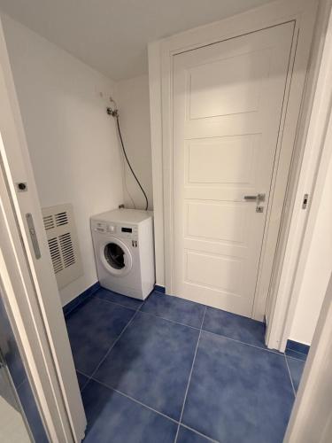 a laundry room with a white door and a washing machine at Casa Buono Holidays in Barano d'Ischia