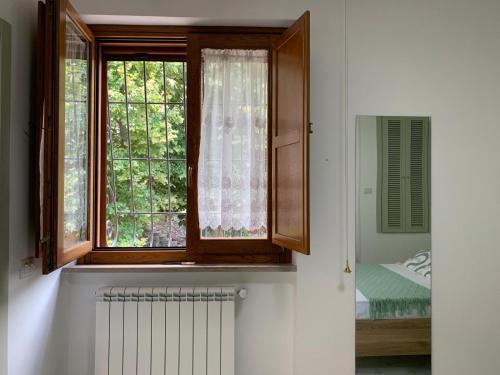 a room with a window with a radiator and a bed at Al Castello B&B in Eboli