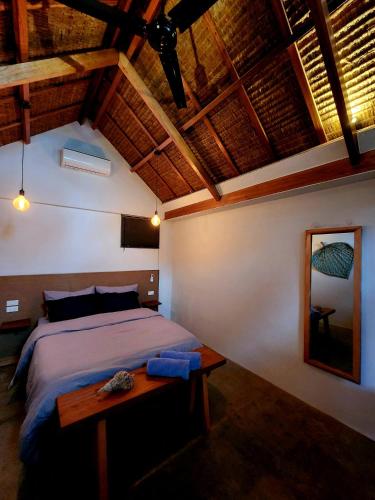 a bedroom with a bed and a wooden table at Marajaw Annex in General Luna