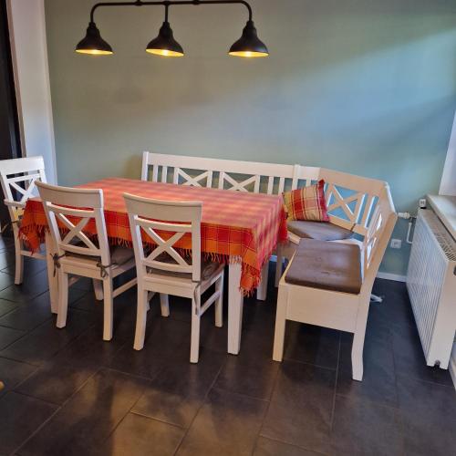 a dining room table and chairs with a red tablecloth at Ferienhaus an der Brandenburgischen Seenplatte in Lindow