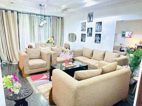 a large living room with couches and a table at Heart of the City Private Room with Amazing Views, Fast WiFi ,AC and walkable in Dar es Salaam