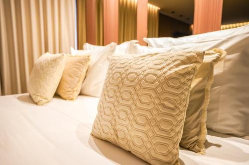 a white bed with four pillows on it at Quinta de Silvalde in Santo Tirso