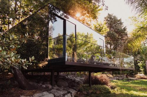 a glass house on a stand in a garden at Quinta de Silvalde in Santo Tirso