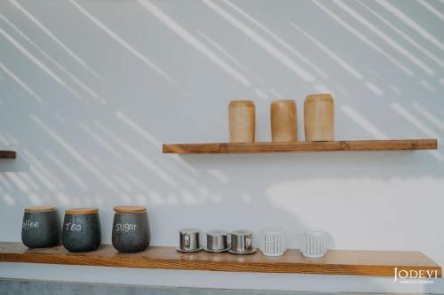 a wooden shelf with several vases on it at Pamela Homestay Cao Bằng in Cao Bằng