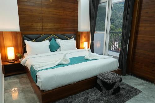 a bedroom with a large bed with towels on it at Hotel Tapovan Hills in Rishīkesh