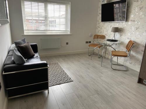 a living room with a couch and a table at Boutique 1 Bdrm Duplex Suite on Marina-301 in Hull