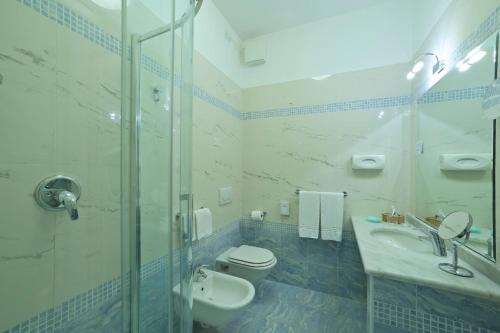 a bathroom with a toilet and a sink and a shower at Residence Atlantic in Alassio