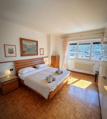 a bedroom with a bed with two towels on it at Art & Lake Apartment in Lecco