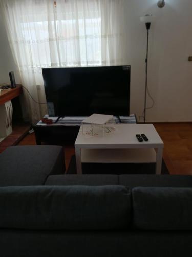 a living room with a couch and a table at Moradia Maria Do Ceu in Vieira de Leiria