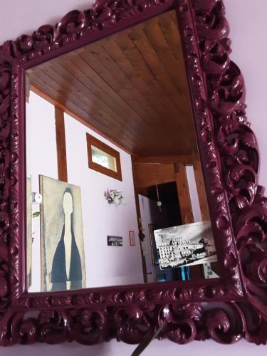 a mirror on a wall with a picture of a woman at 'O Chalet in Pozzuoli
