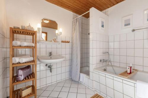 a bathroom with a tub and a sink at Muschel in Fehmarn