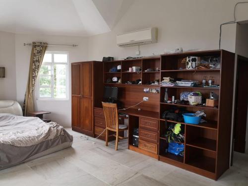 a bedroom with a desk and a bed at La Gaulette Seaview Villa in La Gaulette