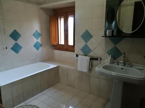 a bathroom with a tub and a sink and a bath tubermottermott at La dimora di Radha B&B Centro Olistico in Rende