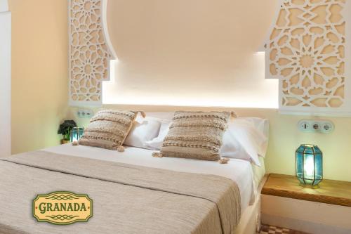 a bedroom with a bed with white sheets and pillows at Mi Andalusia Hotel Experience in Málaga