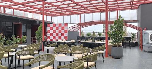 an empty patio with tables and chairs in a building at PubliQ Luxury Stays in Hyderabad