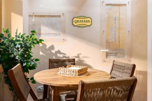 a wooden table with a cake on top of it at Mi Andalusia Hotel Experience in Málaga