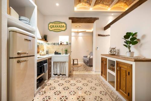 a kitchen with a refrigerator and a stove at Mi Andalusia Hotel Experience in Málaga