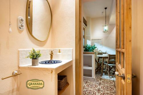 a bathroom with a sink and a mirror on the wall at Mi Andalusia Hotel Experience in Málaga
