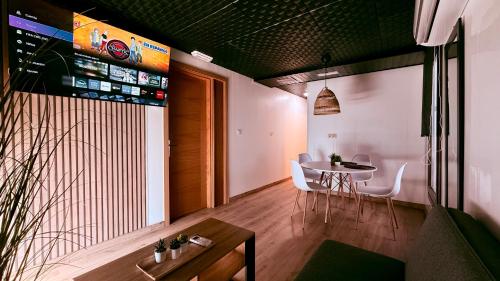 a dining room with a table and white chairs at Apartamentos villa Carolina in Porriño