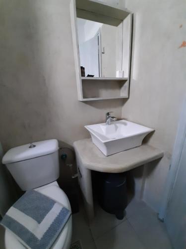 a bathroom with a sink and a toilet and a mirror at Romantza δωμάτιο 4 in Mérikhas