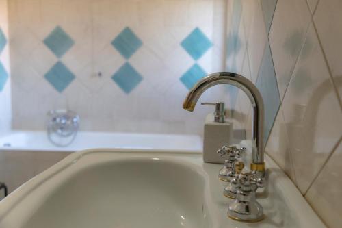 a white sink with a faucet in a bathroom at La dimora di Radha B&B Centro Olistico in Rende